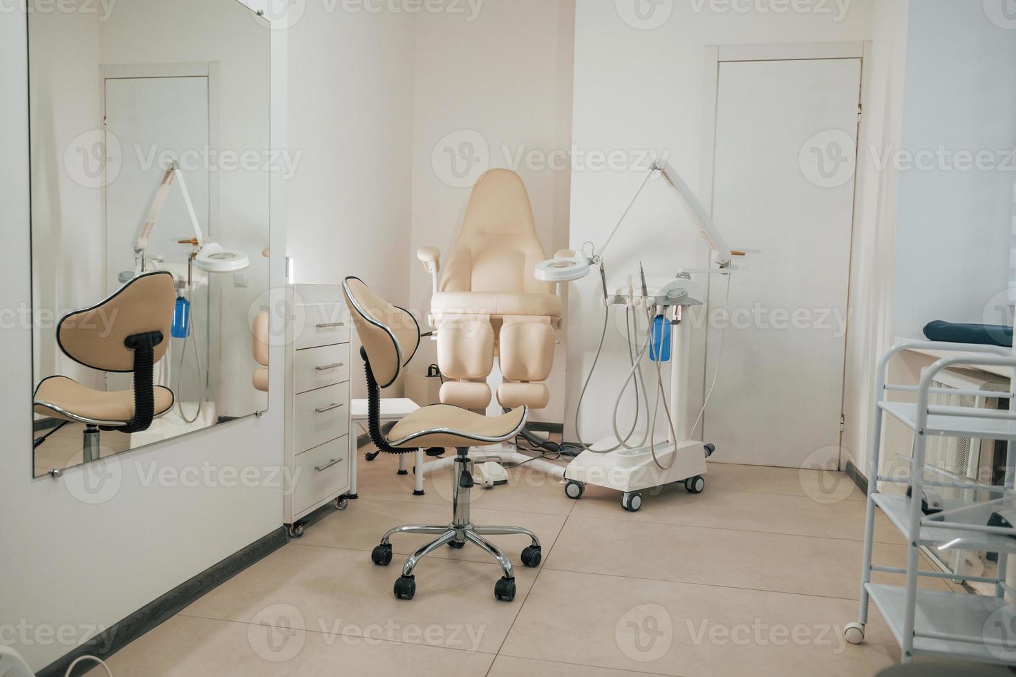 Modern interior of clinic cabinet with chairs and medical tools photo