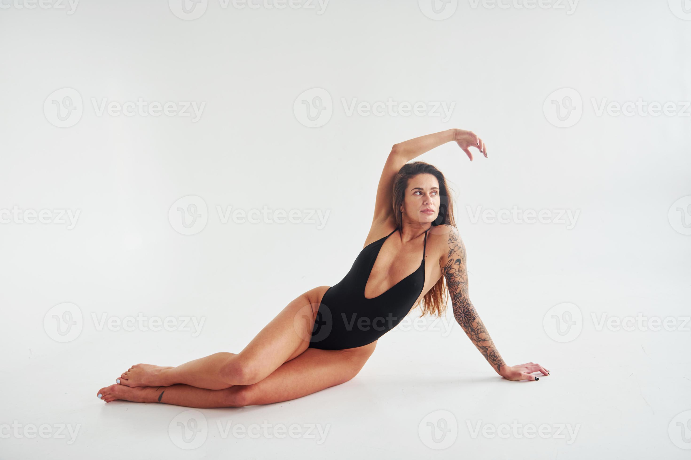 Model with Tattoos Posing in Bodysuit · Free Stock Photo