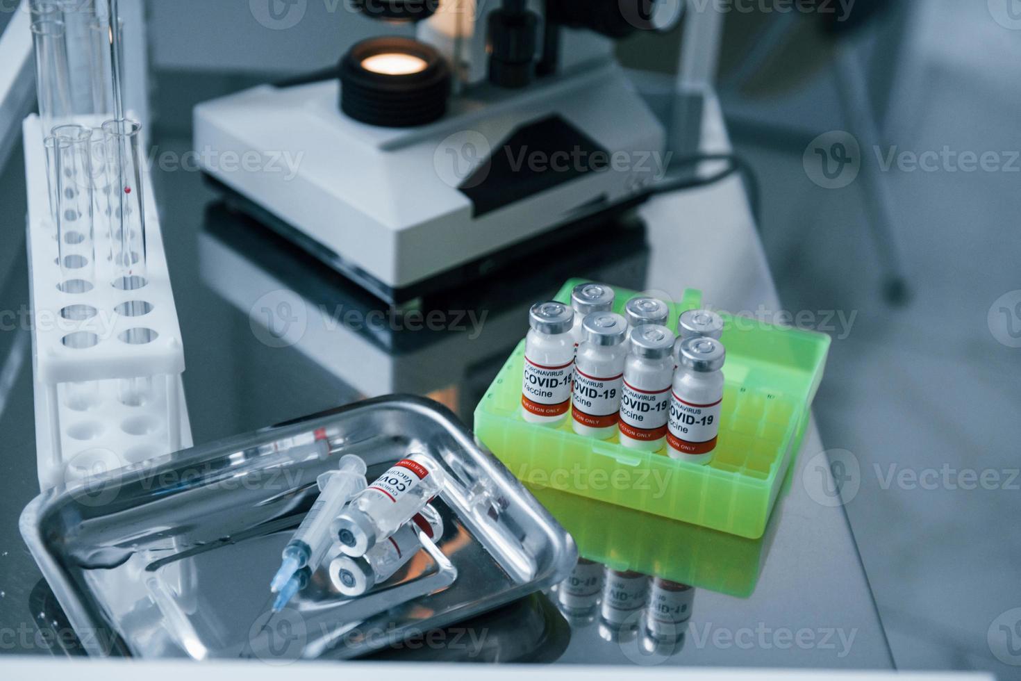 Close up view of COVID-19 vaccine in test tubes in the laboratory photo