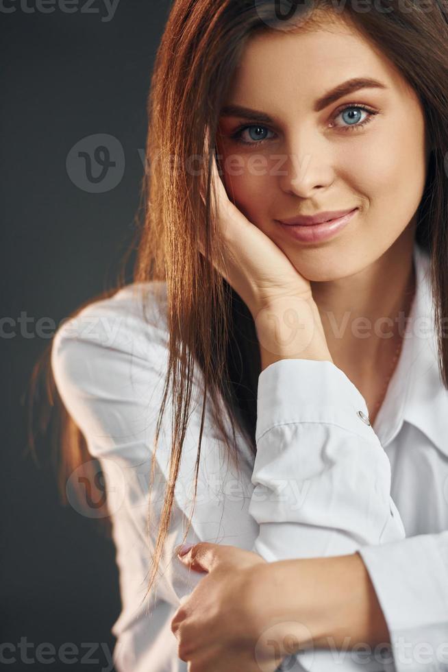 Portrait of young beautiful woman that posing for the camera in the studio photo