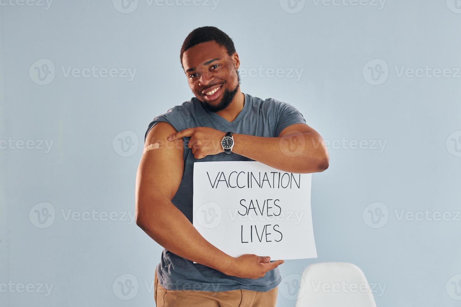 Vaccination saves lives banner. Young african american man after vaccine injection photo