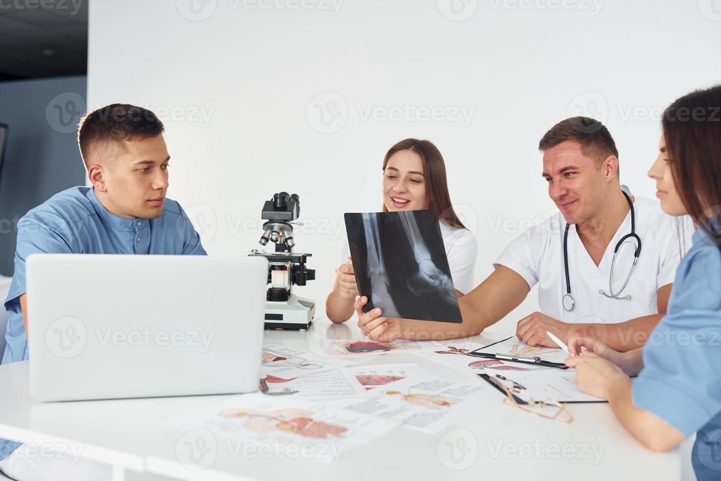 X-ray of legs. Group of young doctors is working together in the modern office photo