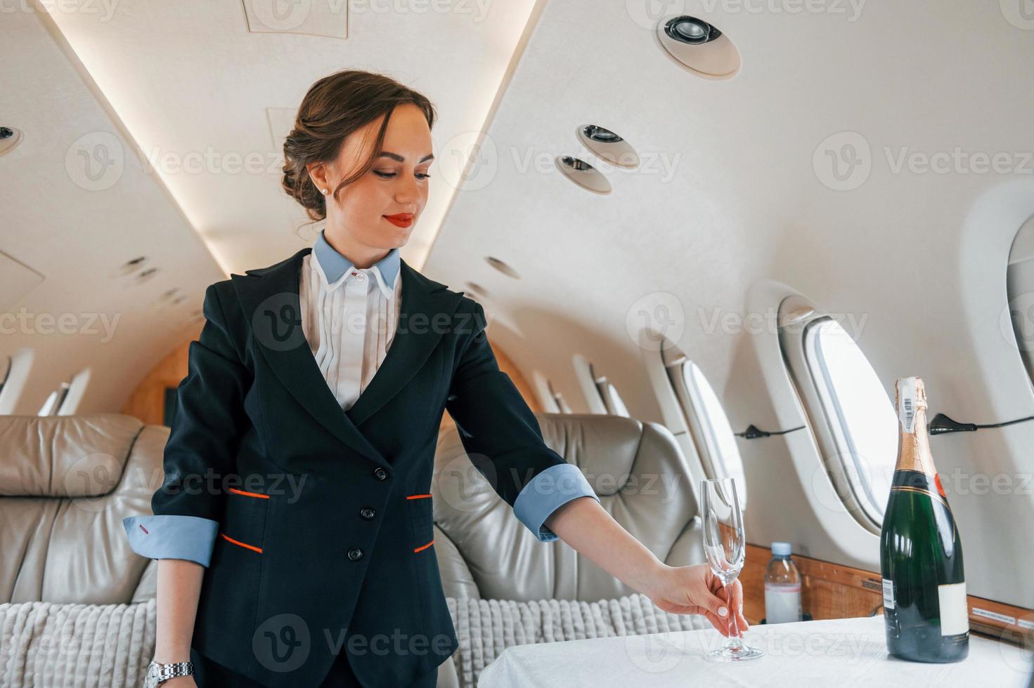 Young stewardess on the work in the passanger airplane photo
