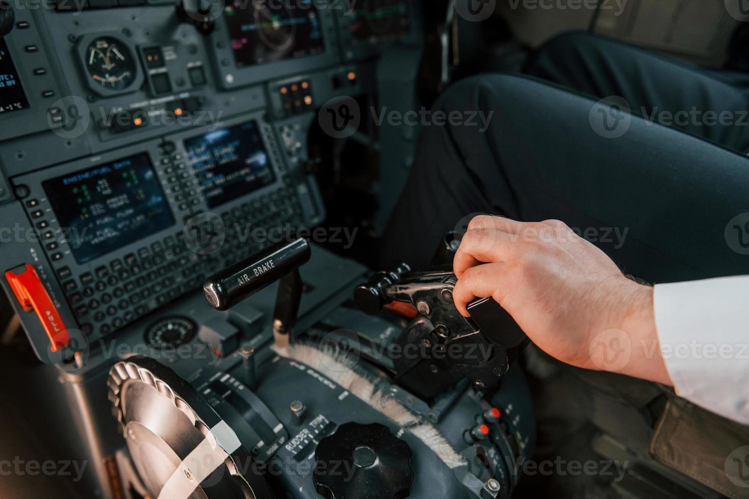 Close up view. Pilot on the work in the passenger airplane. Preparing for takeoff photo