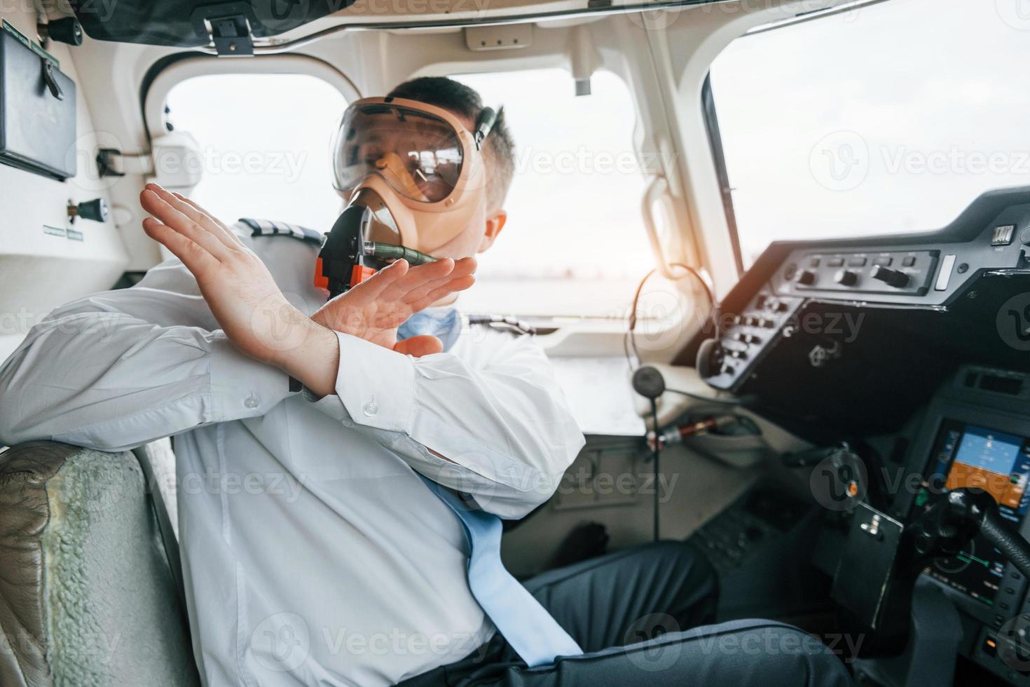 In oxygen mask. Pilot on the work in the passenger airplane. Preparing for takeoff photo
