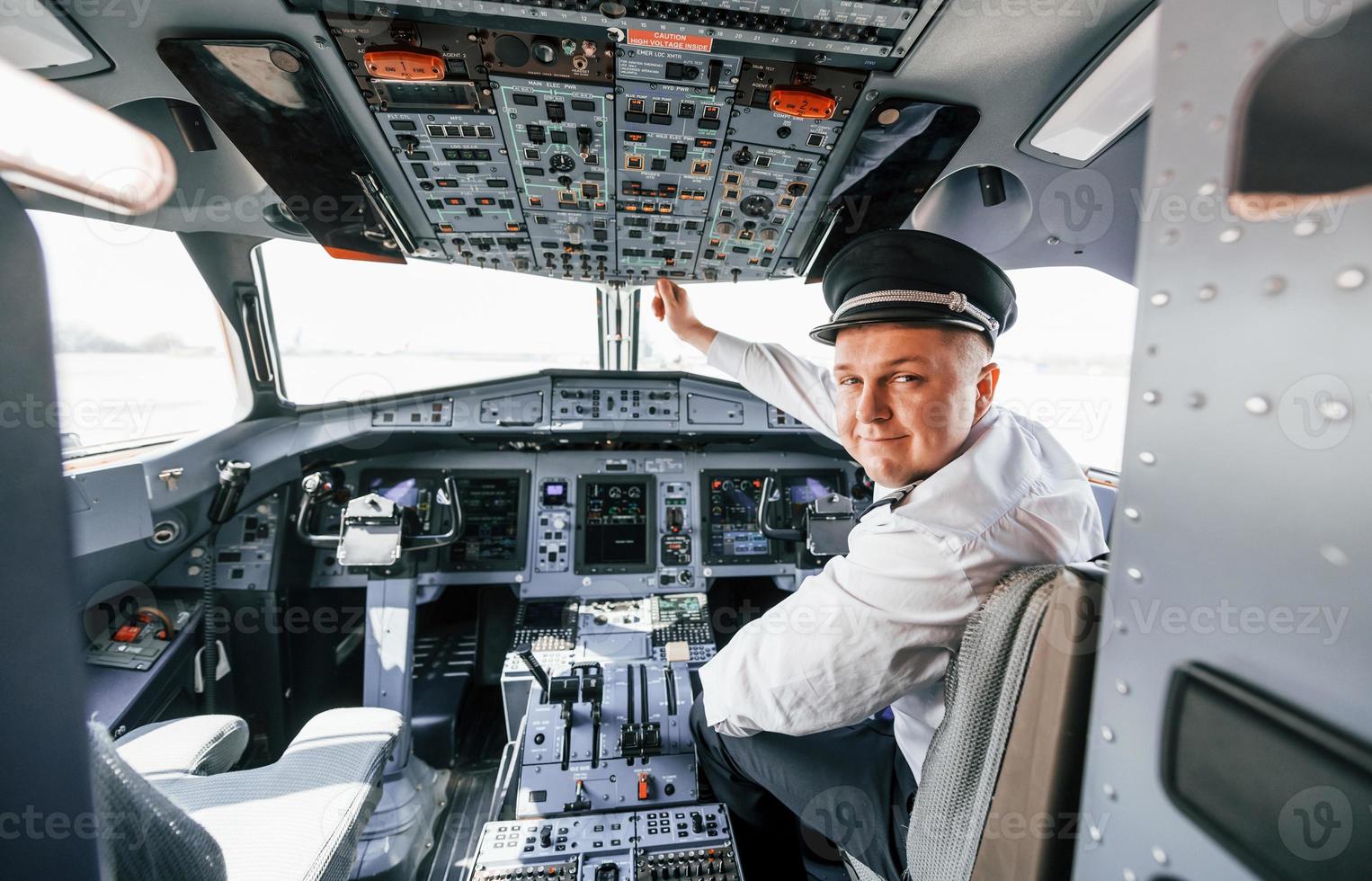 Control of the flight. Pilot on the work in the passenger airplane. Preparing for takeoff photo