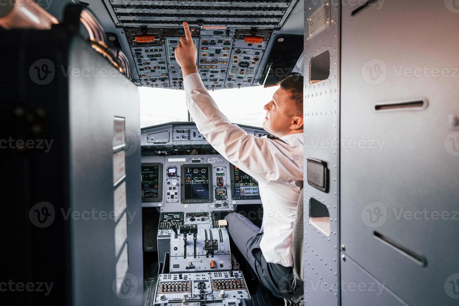 Control of the flight. Pilot on the work in the passenger airplane. Preparing for takeoff photo