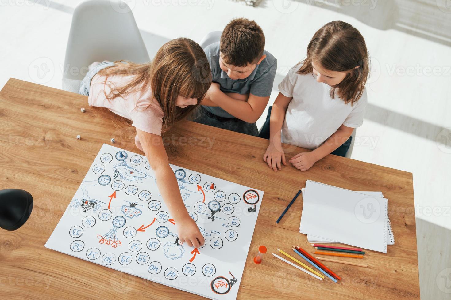 Step by step game. Kids having fun in the domestic room at daytime together photo