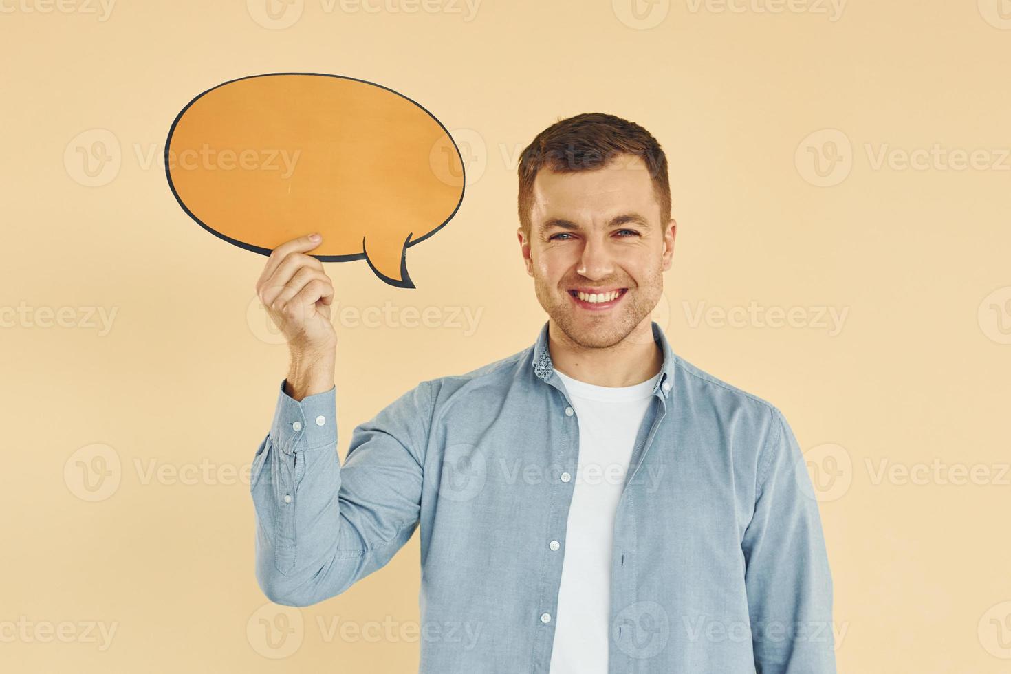 emociones positivas. hombre de pie en el estudio con carteles vacíos para el texto foto