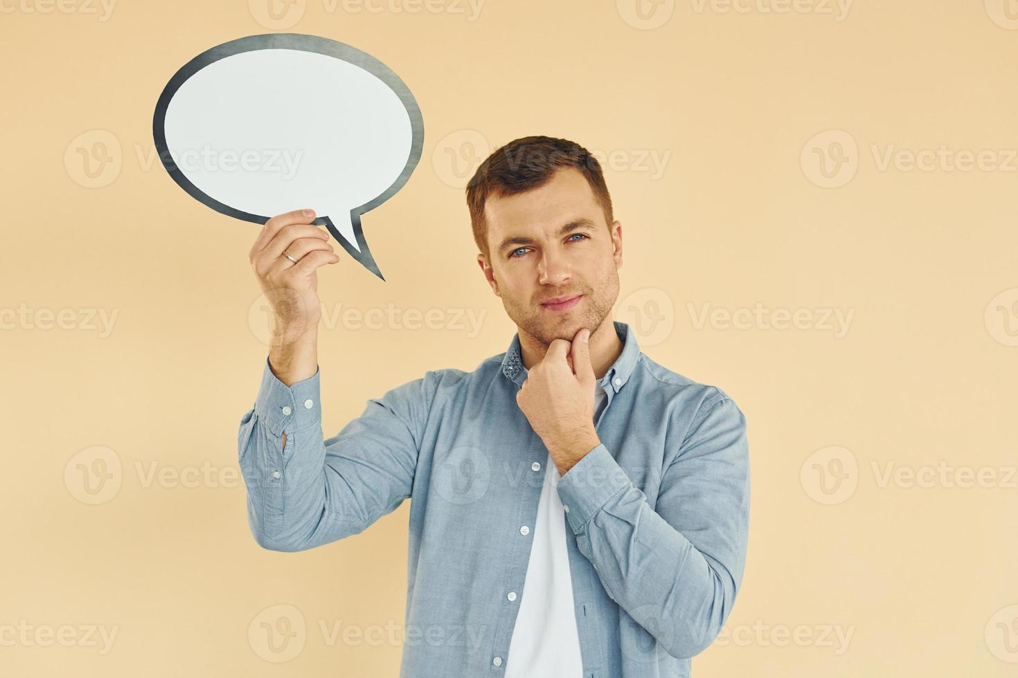 Positive emotions. Man standing in the studio with empty signs for the text photo