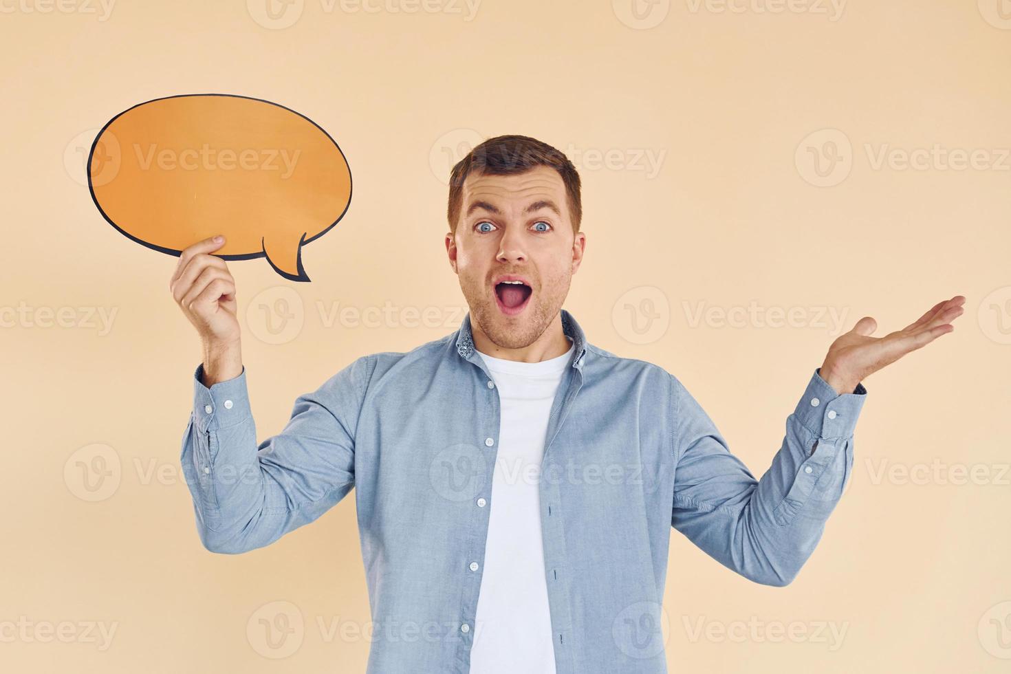 Facial expression. Man standing in the studio with empty signs for the text photo