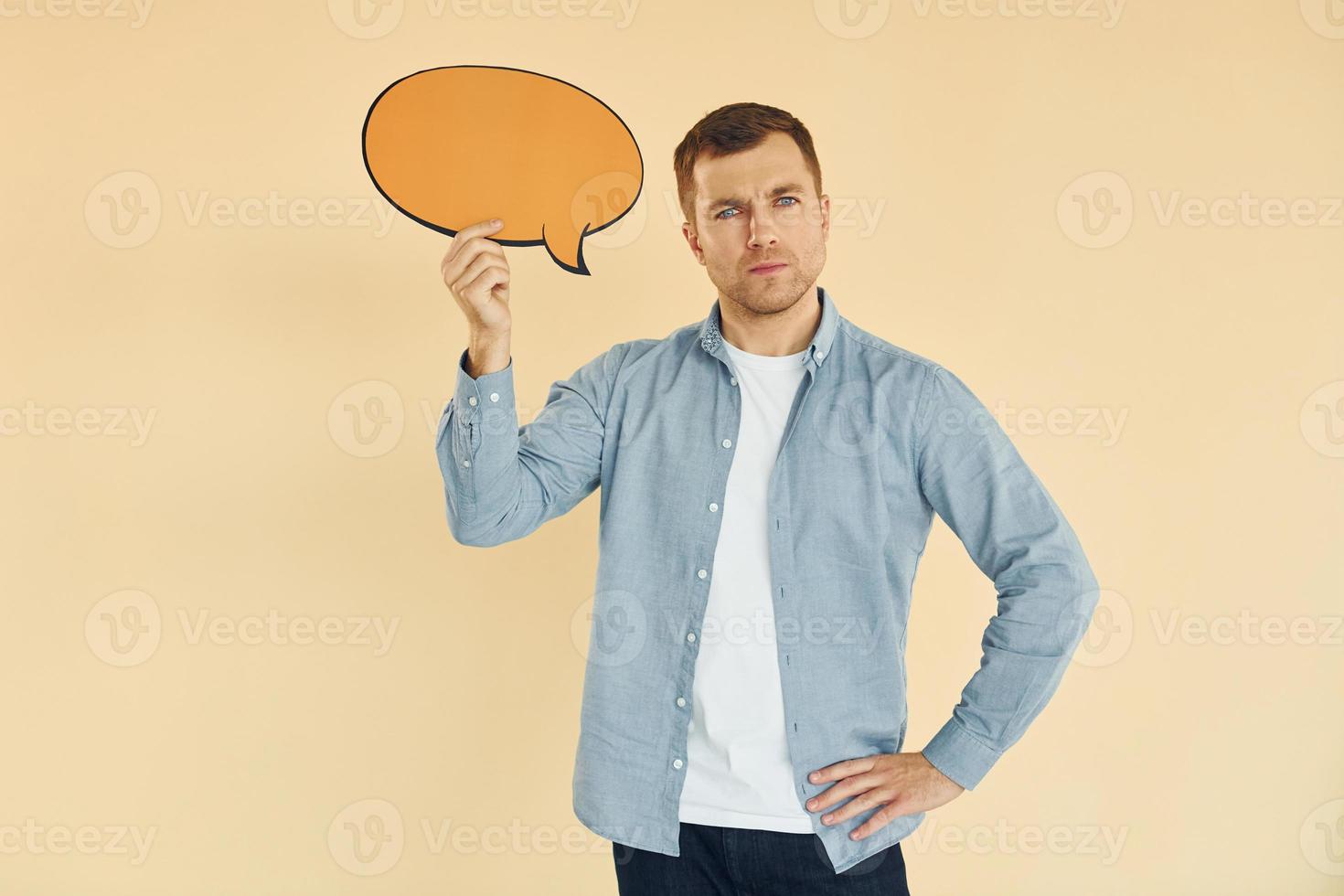 Positive emotions. Man standing in the studio with empty signs for the text photo