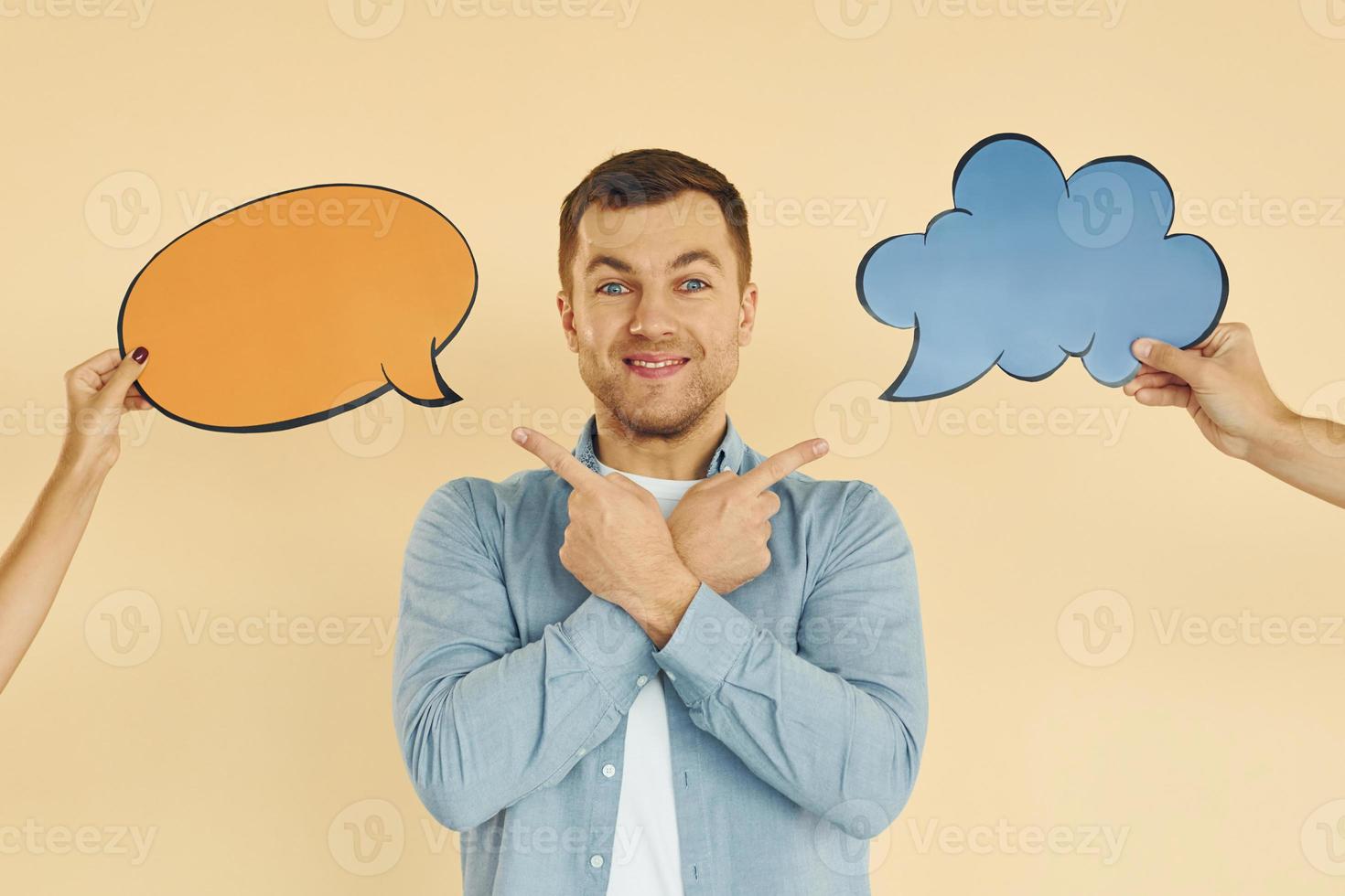 Tough choice between two ideas. Man standing in the studio with empty signs for the text photo