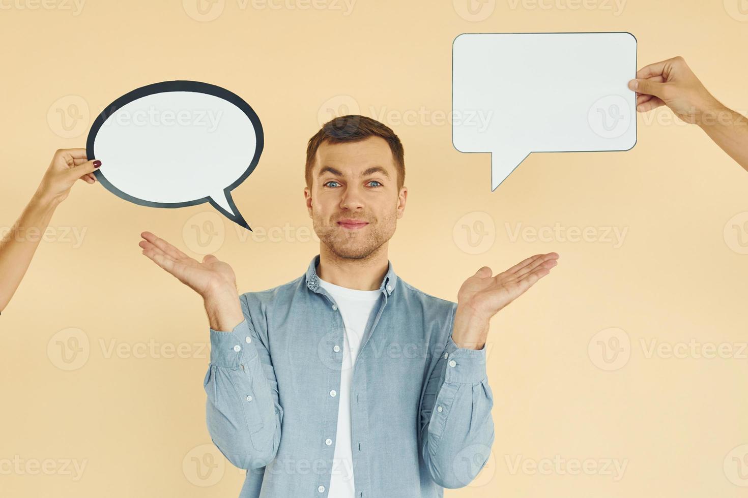 Different thoughts. Man standing in the studio with empty signs for the text photo