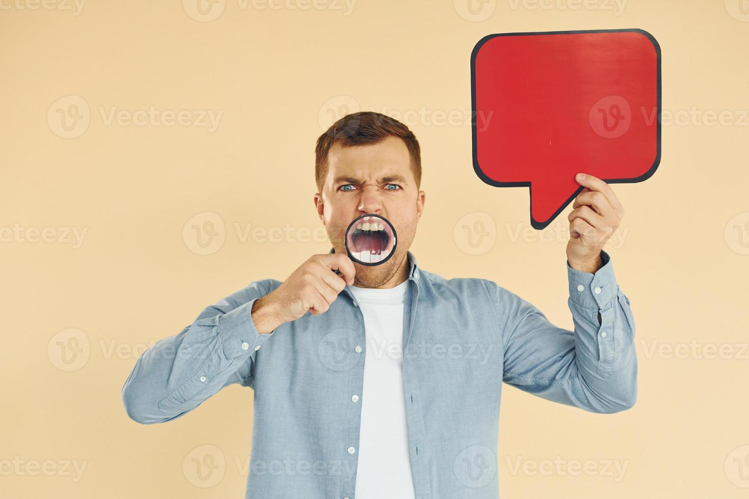 Angry and mad. Man standing in the studio with empty signs for the text photo