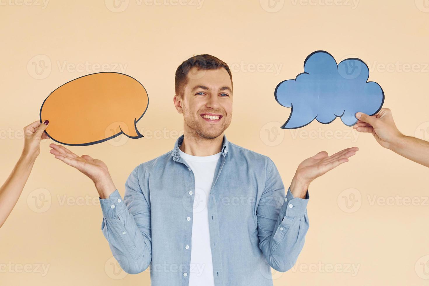 Tough choice between two ideas. Man standing in the studio with empty signs for the text photo