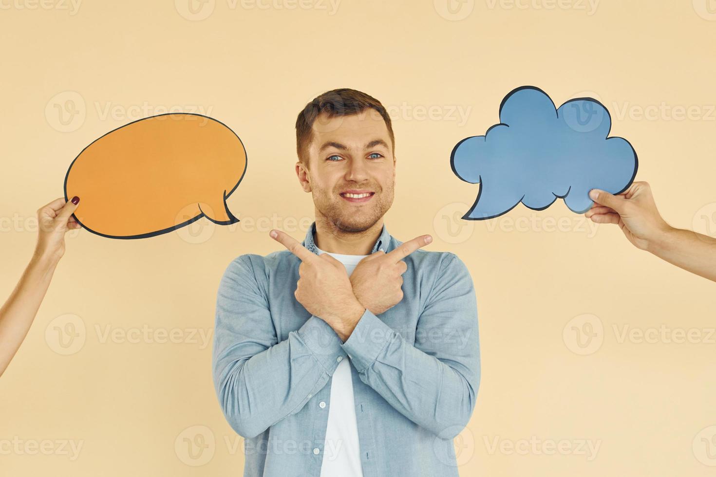 Tough choice between two ideas. Man standing in the studio with empty signs for the text photo