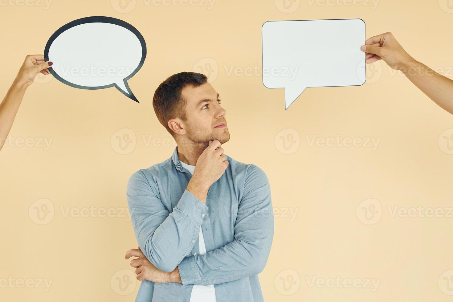 Different thoughts. Man standing in the studio with empty signs for the text photo