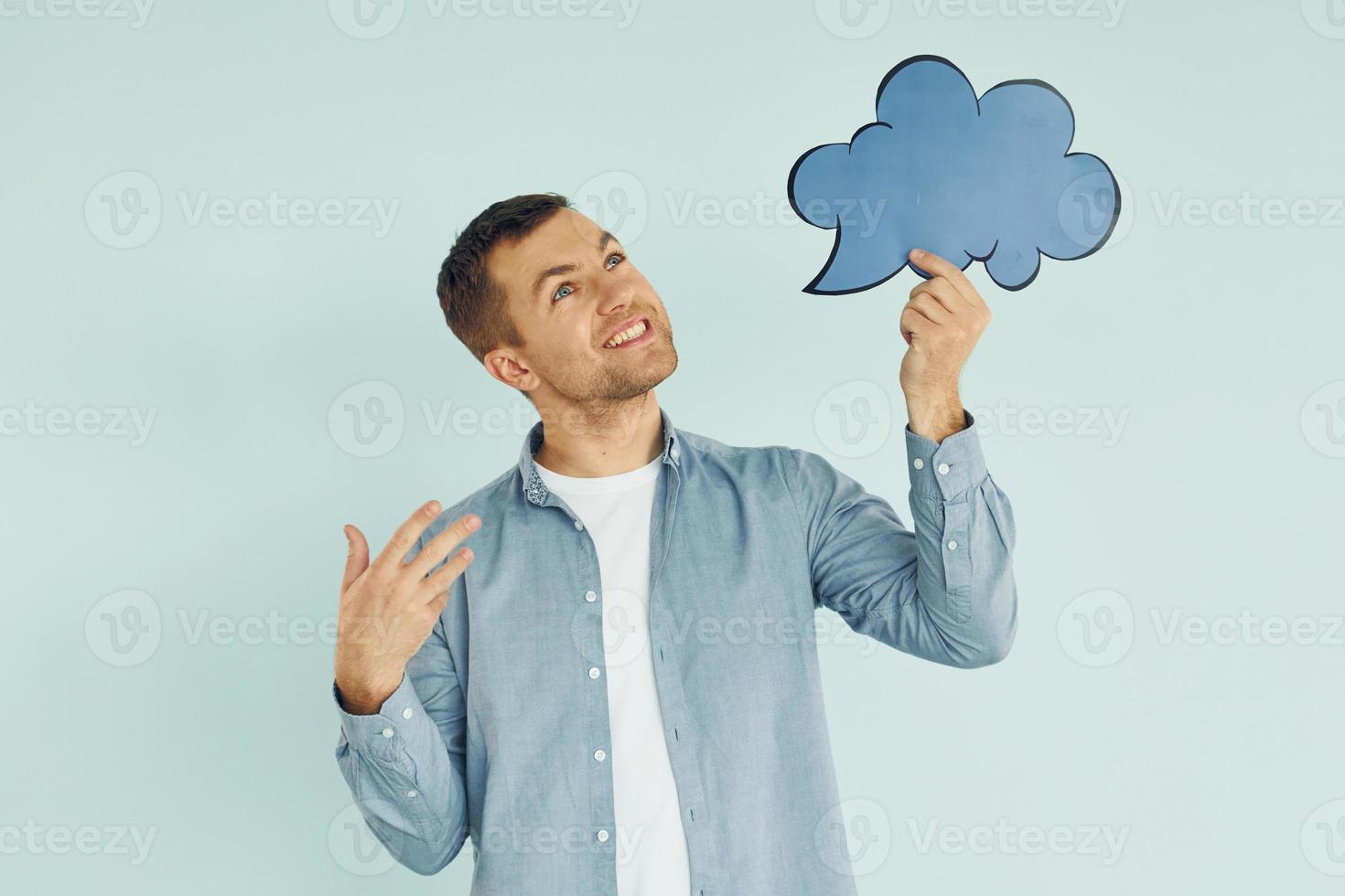 Holding sign. Man standing in the studio photo