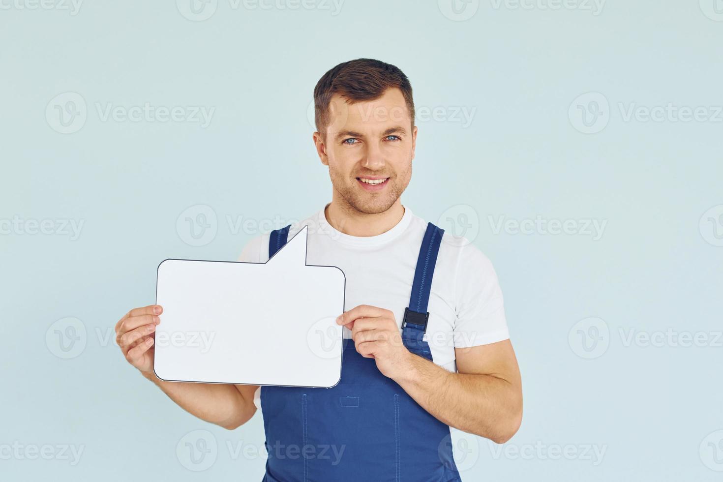 Worker saying something. Man standing in the studio with empty signs for the text photo
