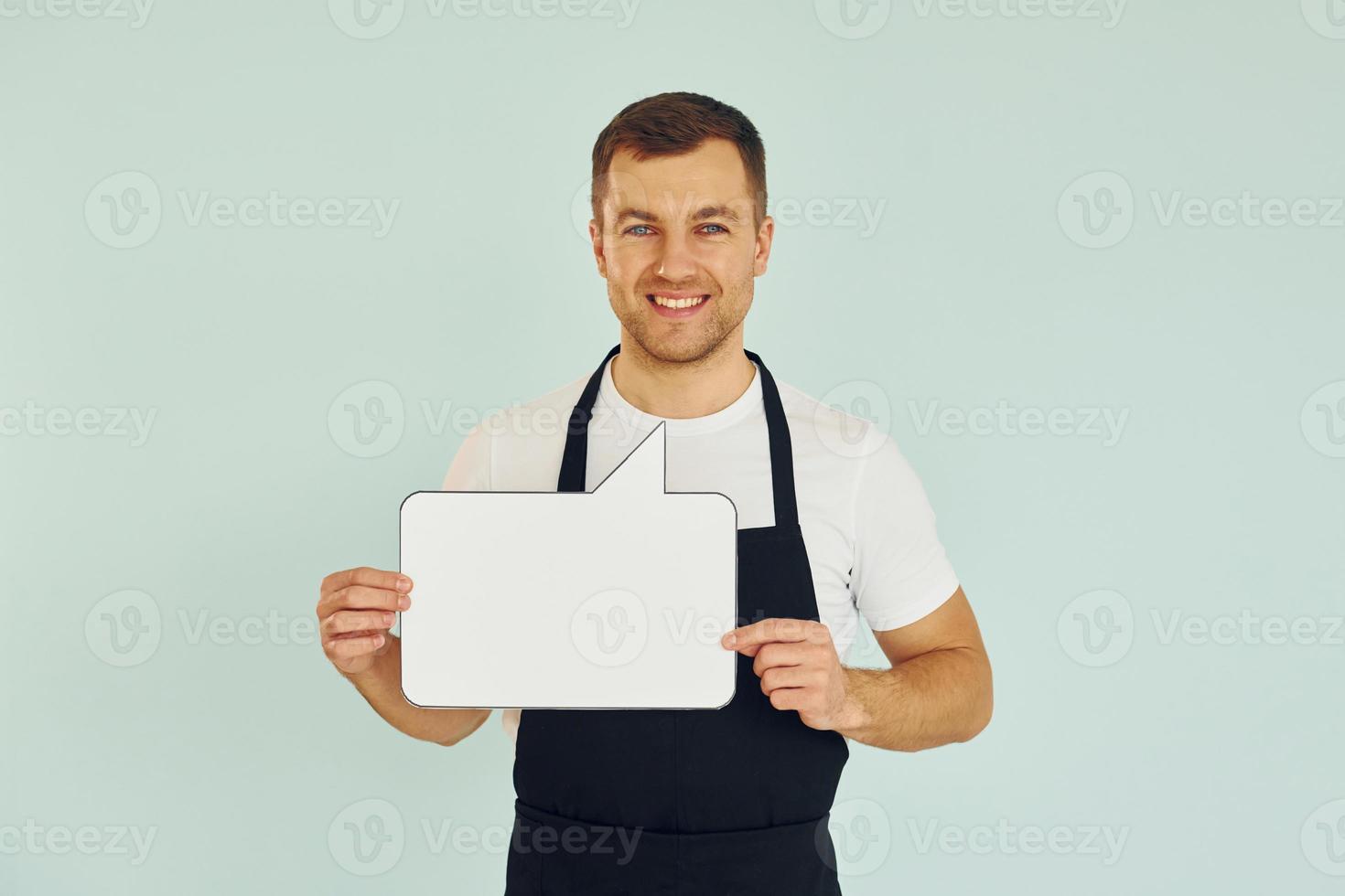 Sincere emotions. Man standing in the studio with empty signs for the text photo