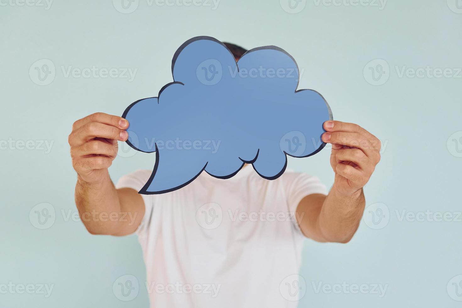 Cloud looking signs. Man standing in the studio photo
