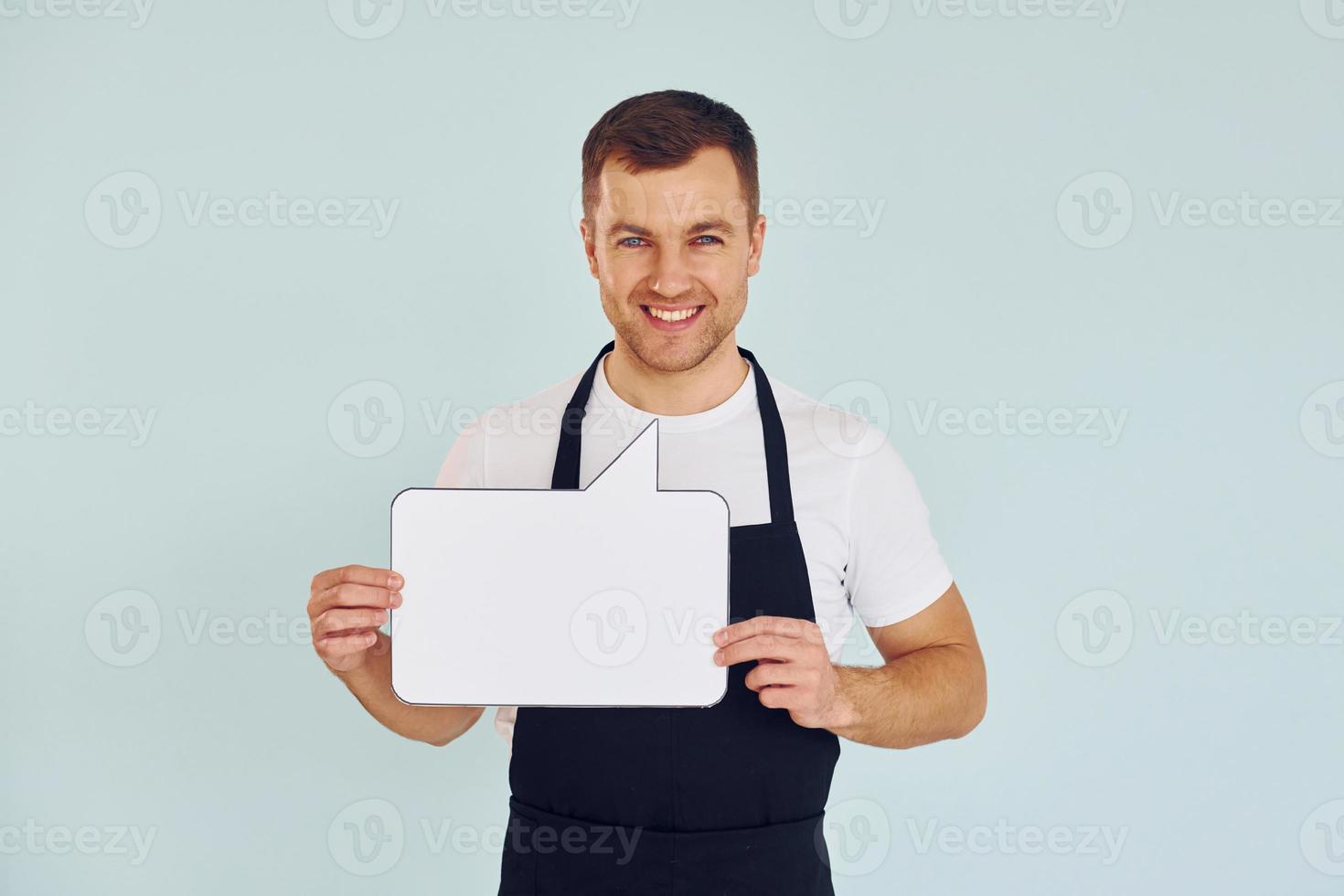 Sincere emotions. Man standing in the studio with empty signs for the text photo