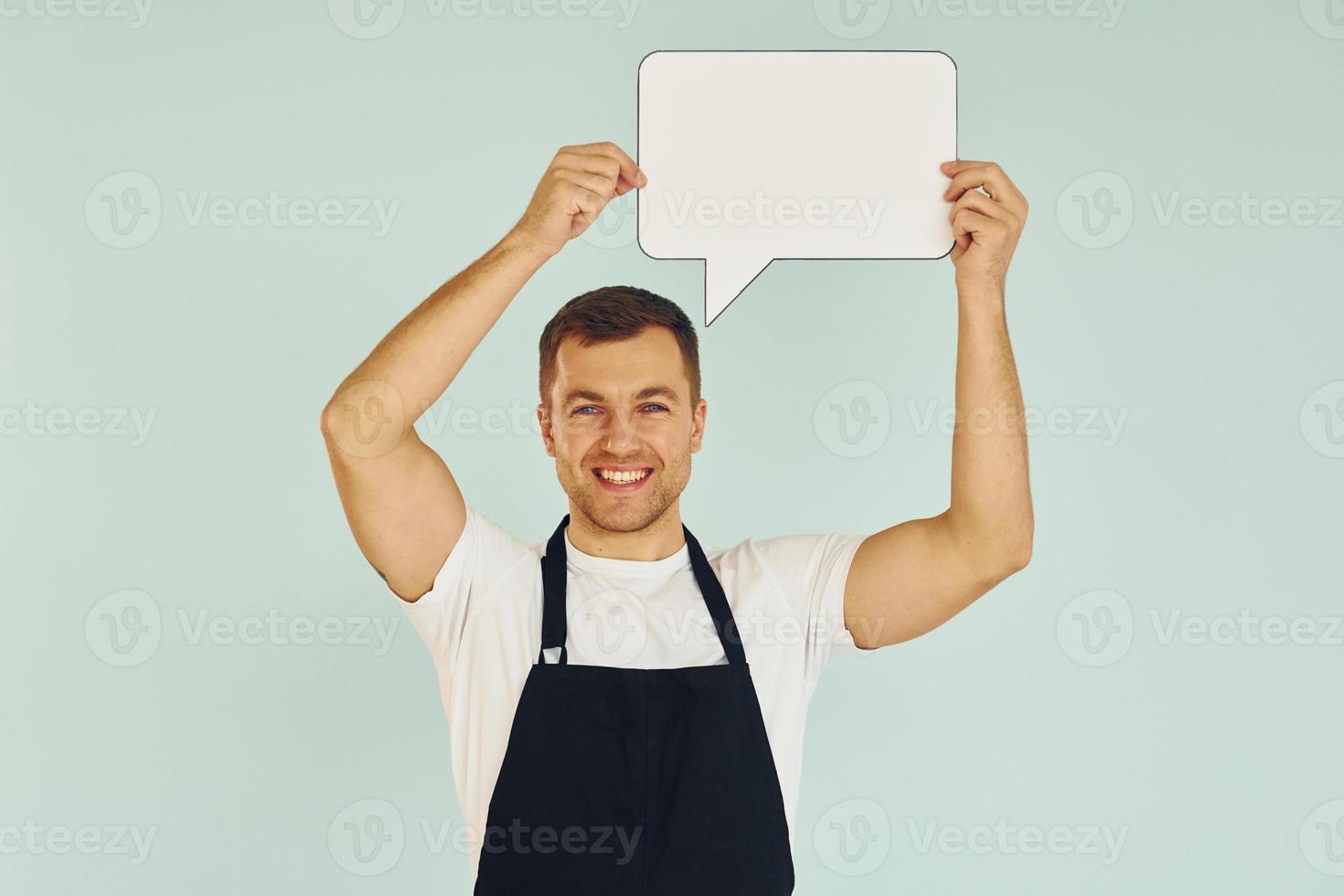 Sincere emotions. Man standing in the studio with empty signs for the text photo