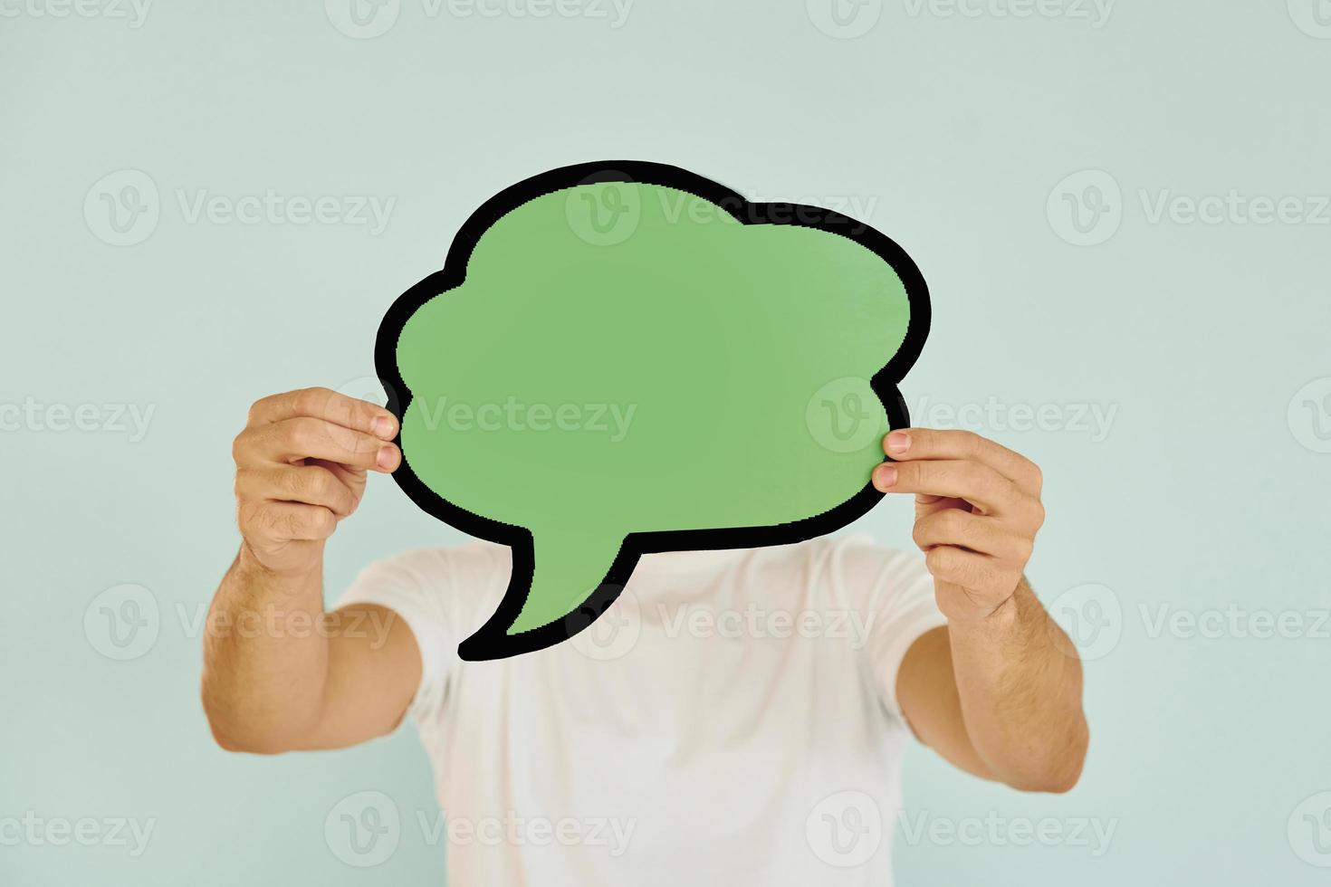 Cloud looking signs. Man standing in the studio photo