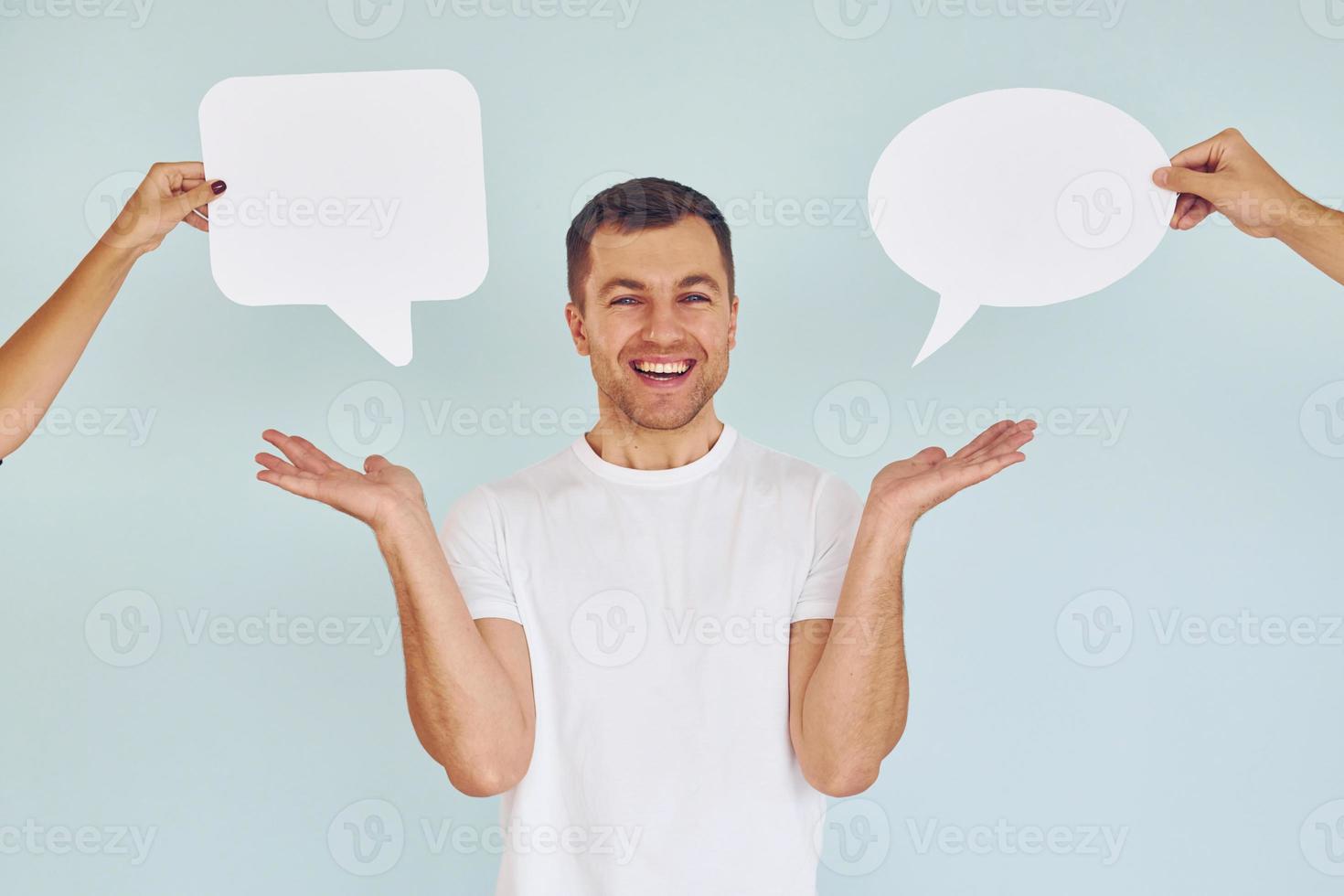 In white shirt. Man standing in the studio with empty signs for the text photo