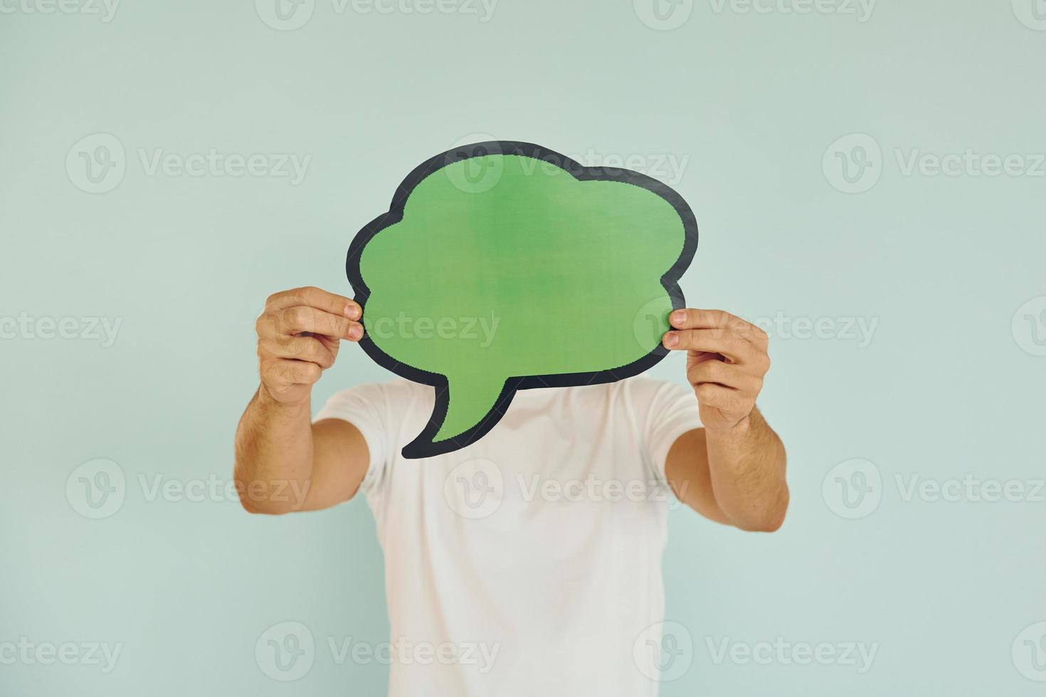 Cloud looking signs. Man standing in the studio photo