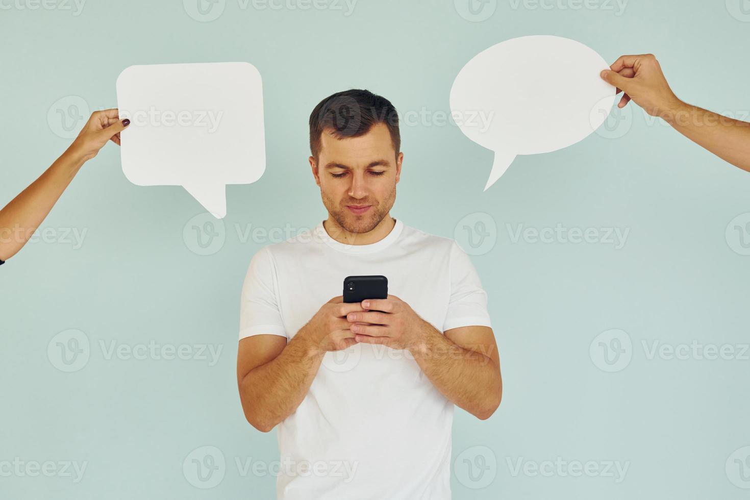 Conversation text. Man standing in the studio with empty signs photo