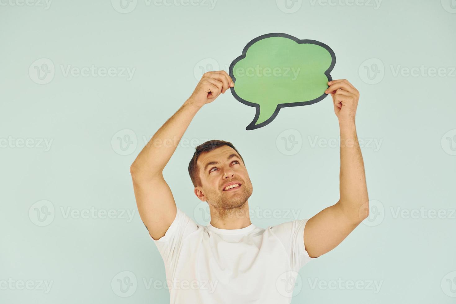 In white shirt. Man standing in the studio with empty signs for the text photo