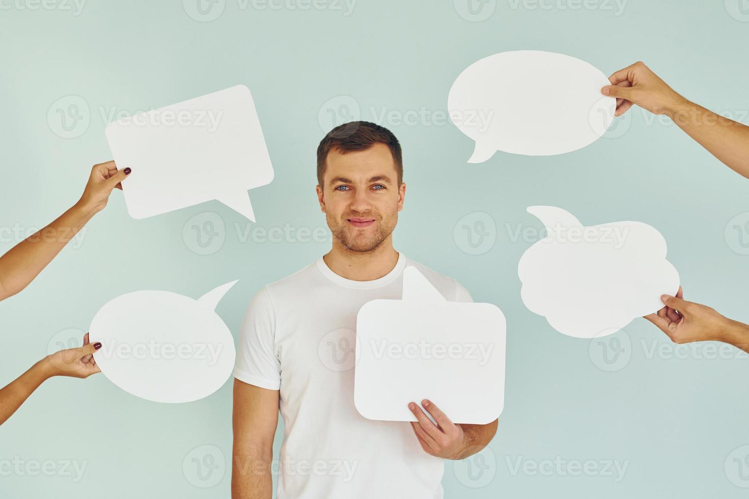 Many of the different thoughts. Man standing in the studio with empty signs for the text photo