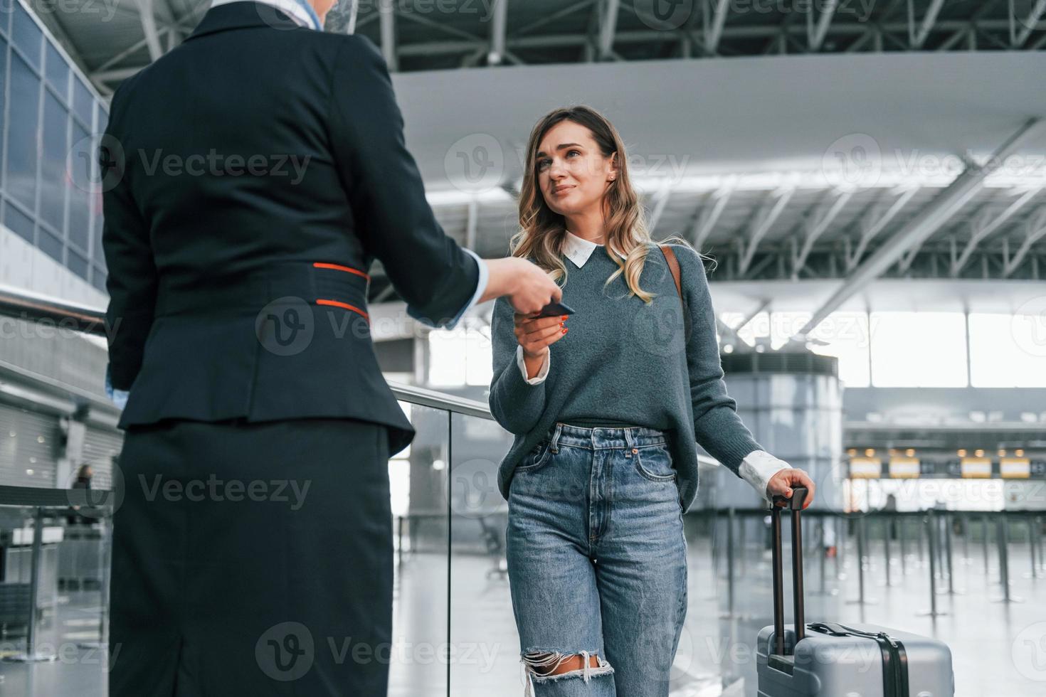 With documents. Young female tourist is in the airport at daytime photo