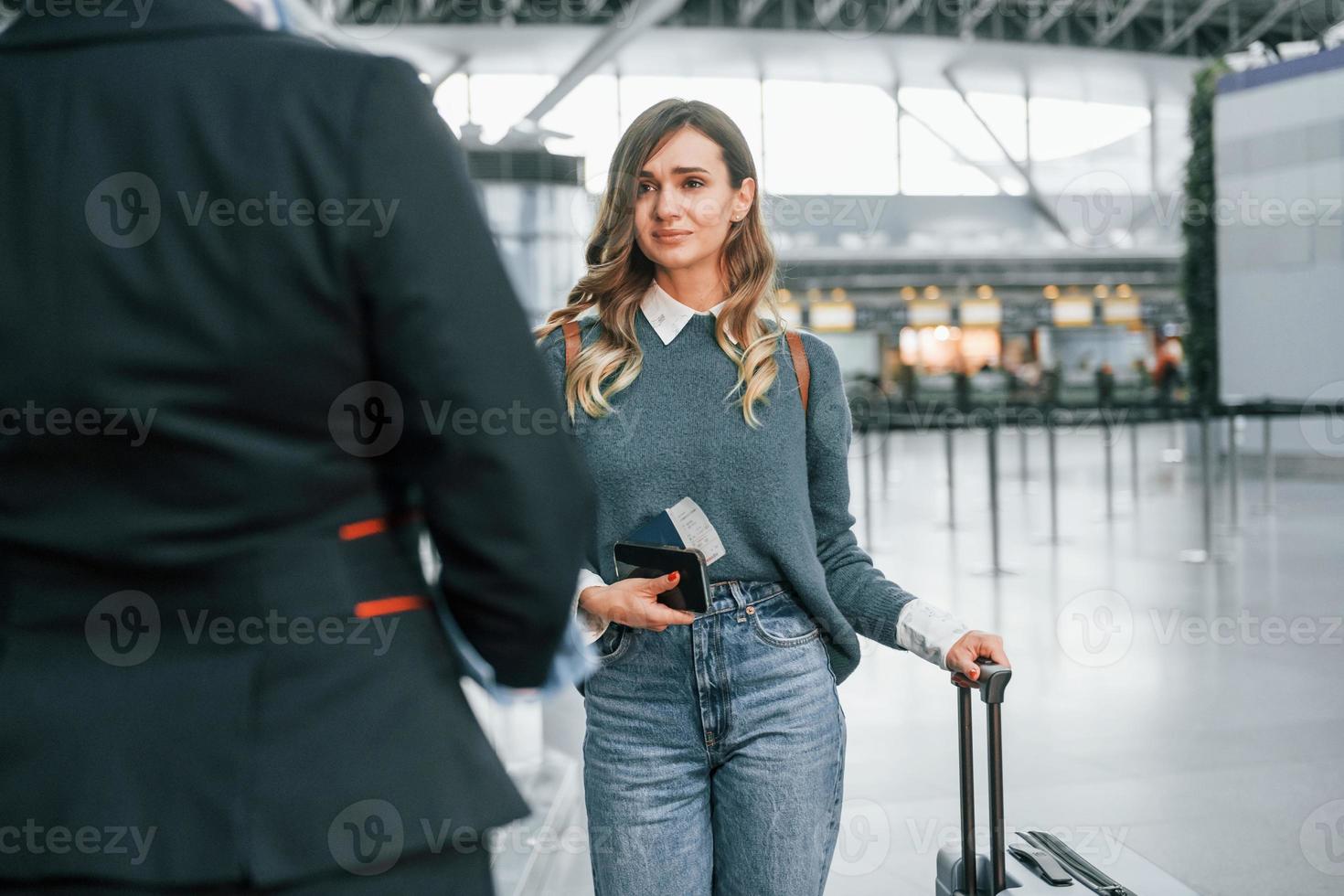 Pass procedure. Young female tourist is in the airport at daytime photo