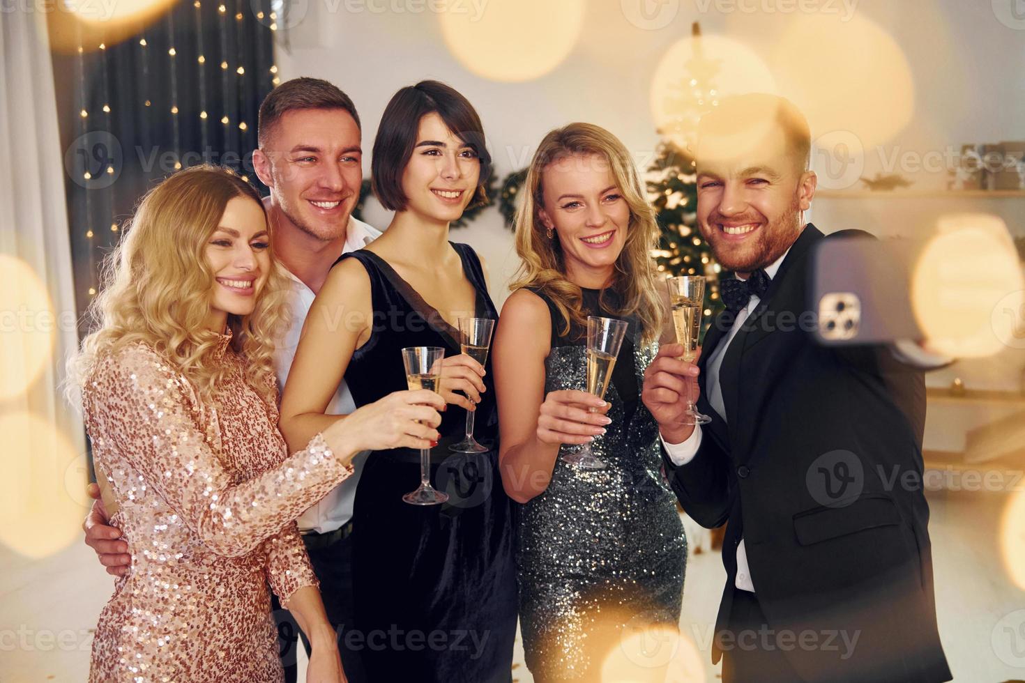 Making selfie. Group of people have a new year party indoors together photo