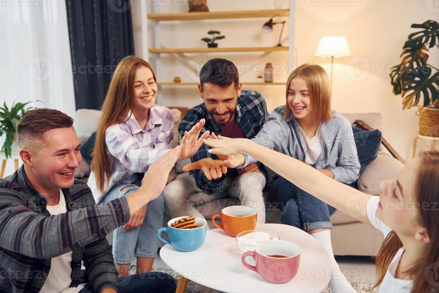 Having fun. Group of friends have party indoors together photo