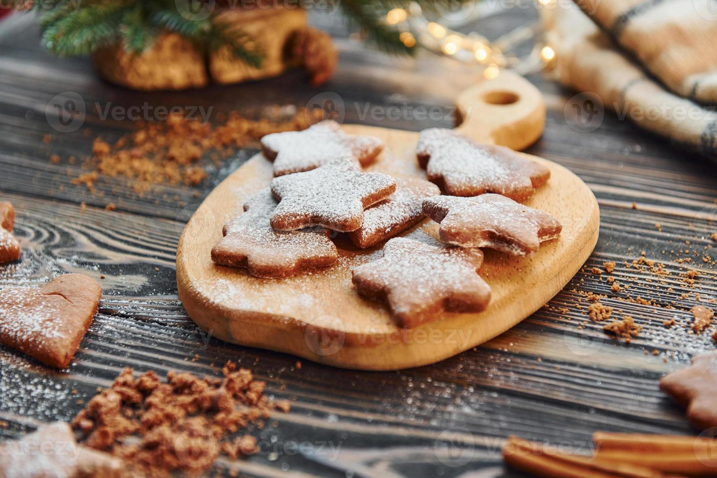 Cookies laying down on the table. Christmas background with holiday decoration photo