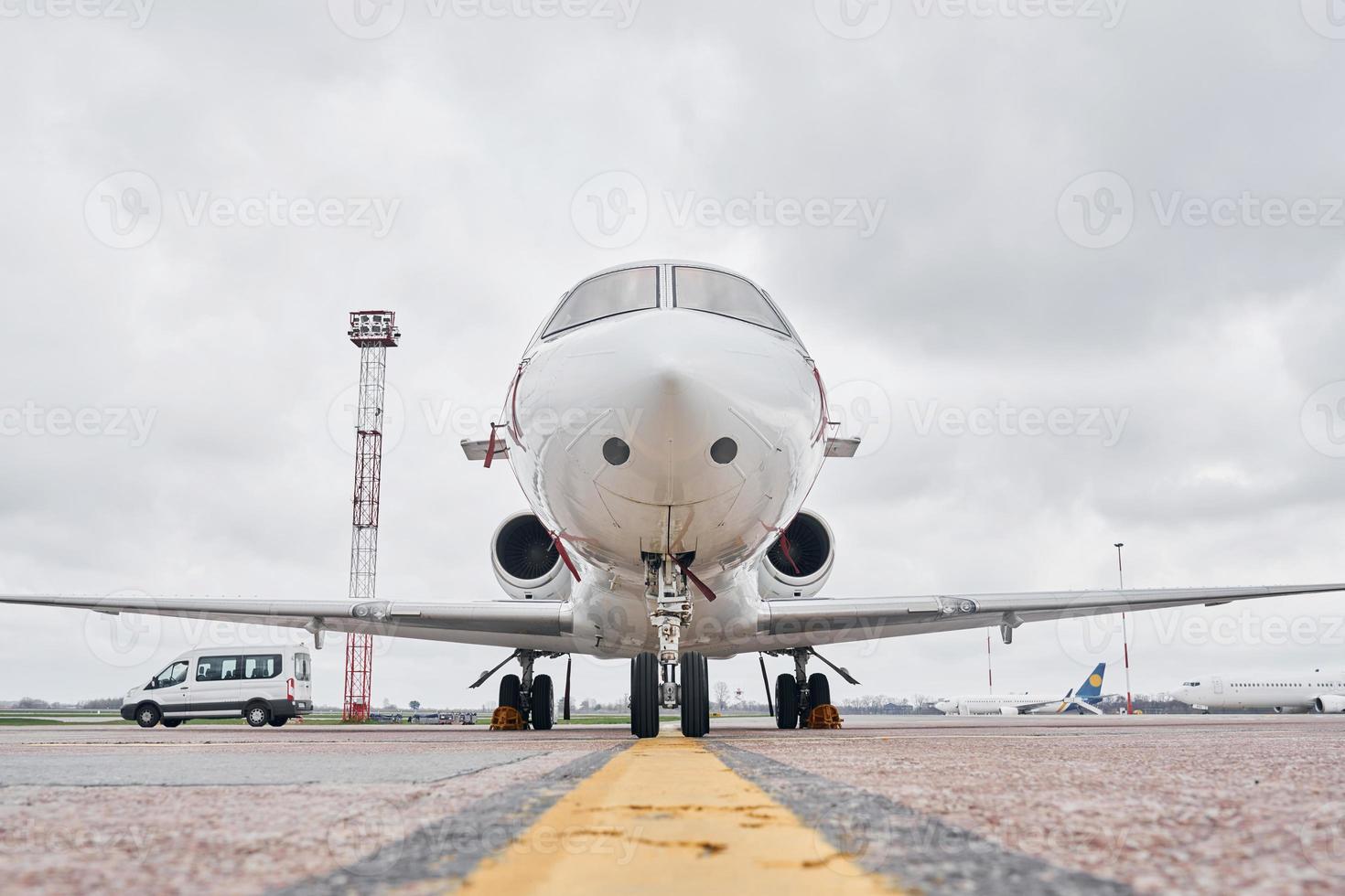 Front view. Turboprop aircraft parked on the runway at daytime photo