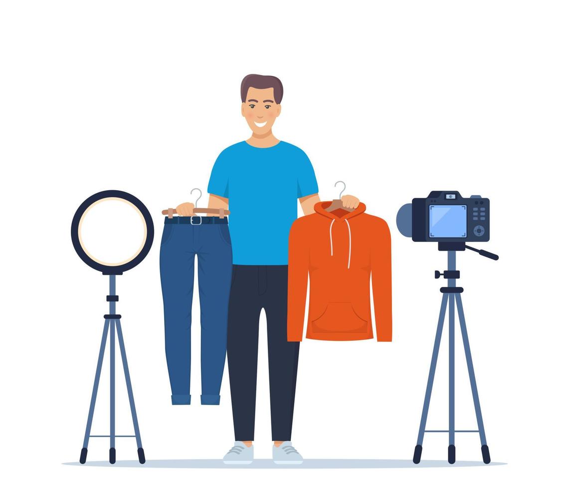 Man blogger records video tips for choosing clothes, shows trending clothing models to his subscribers. Brand or product promotion, marketing campaign in social media. Vector Illustration.