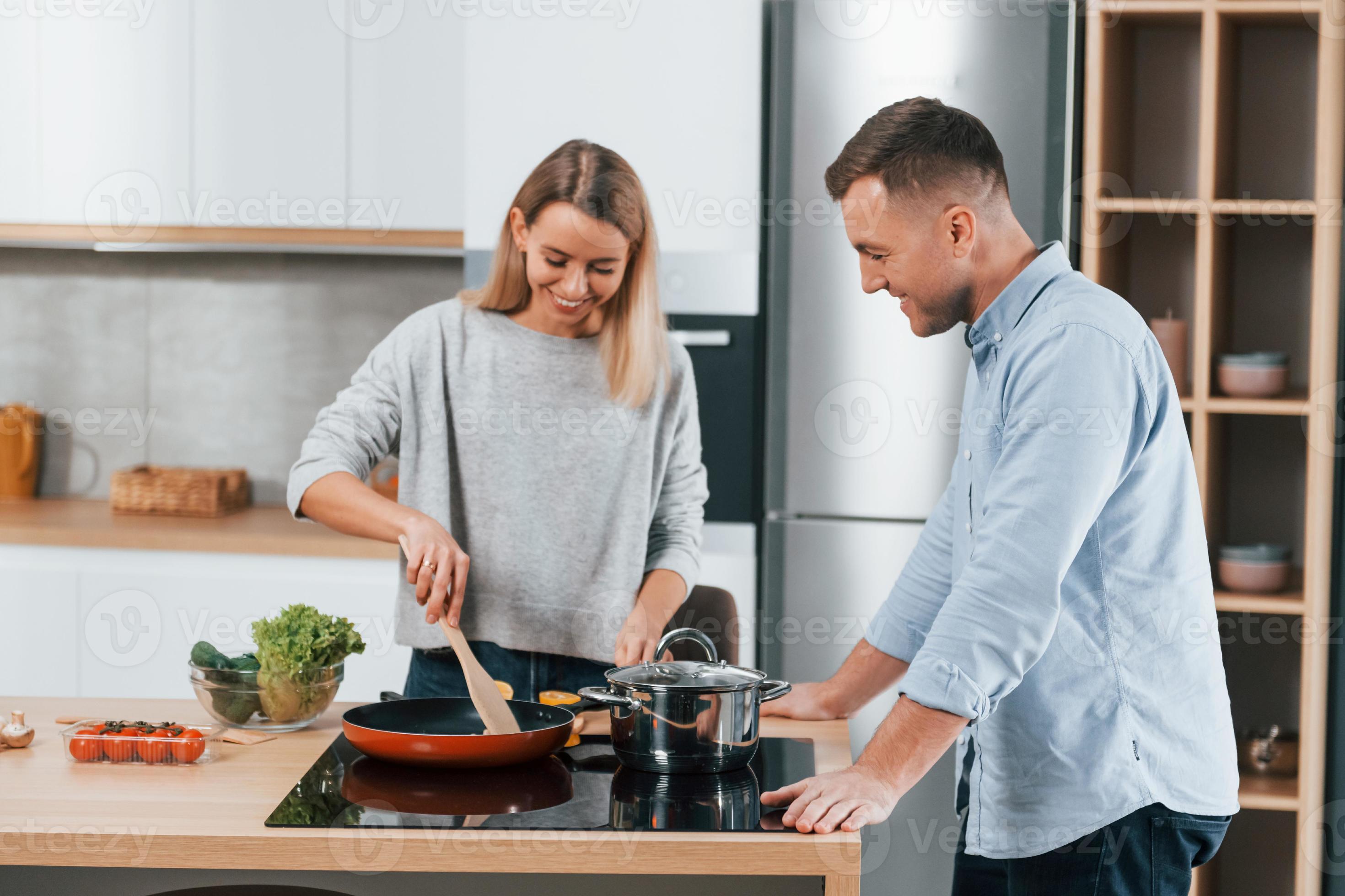 Delicious Dinner Couple Preparing Food At Home On The Modern Kitchen delicious-dinner-couple-preparing-food-at-home-on-the-modern-kitchen