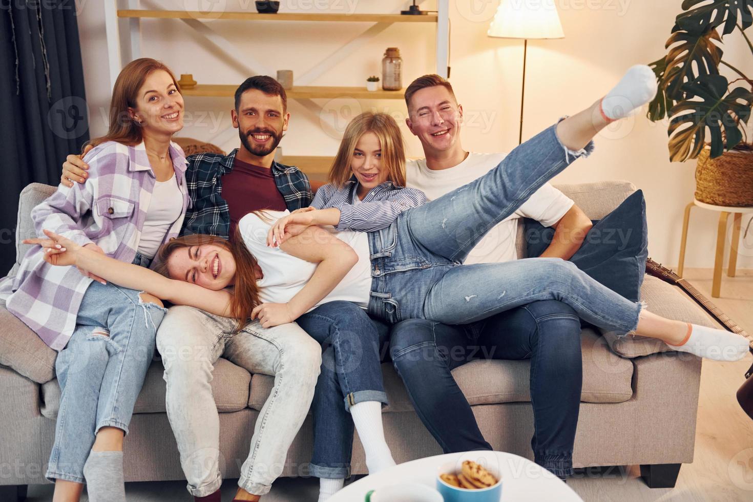 Group of friends have party indoors together photo