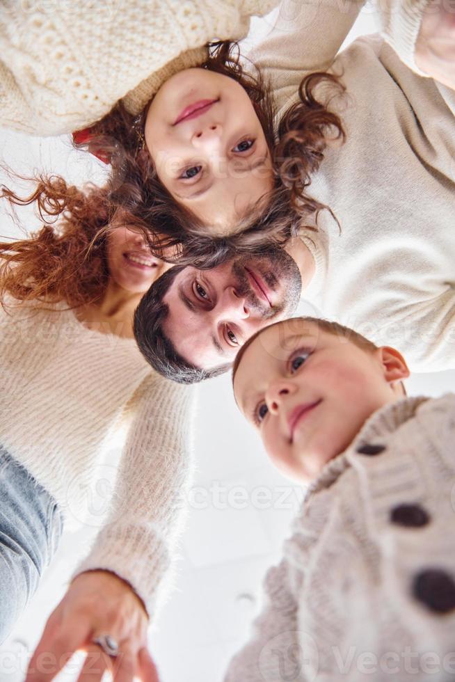 View from below. Happy family looking down and having fun photo