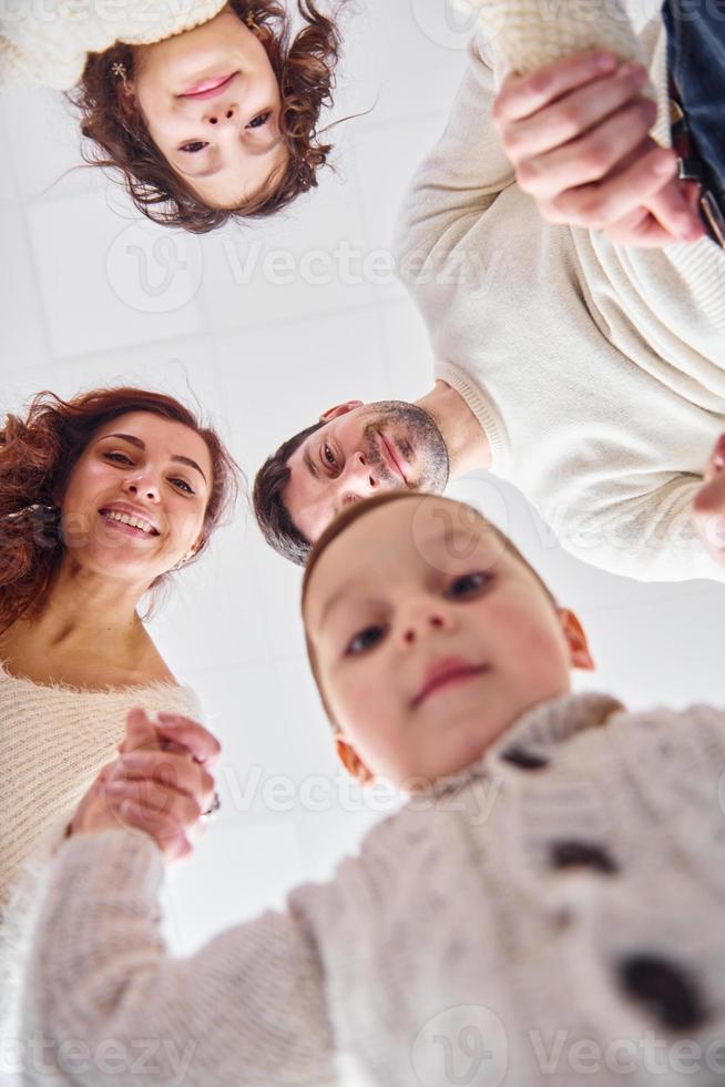 View from below. Happy family looking down and having fun photo