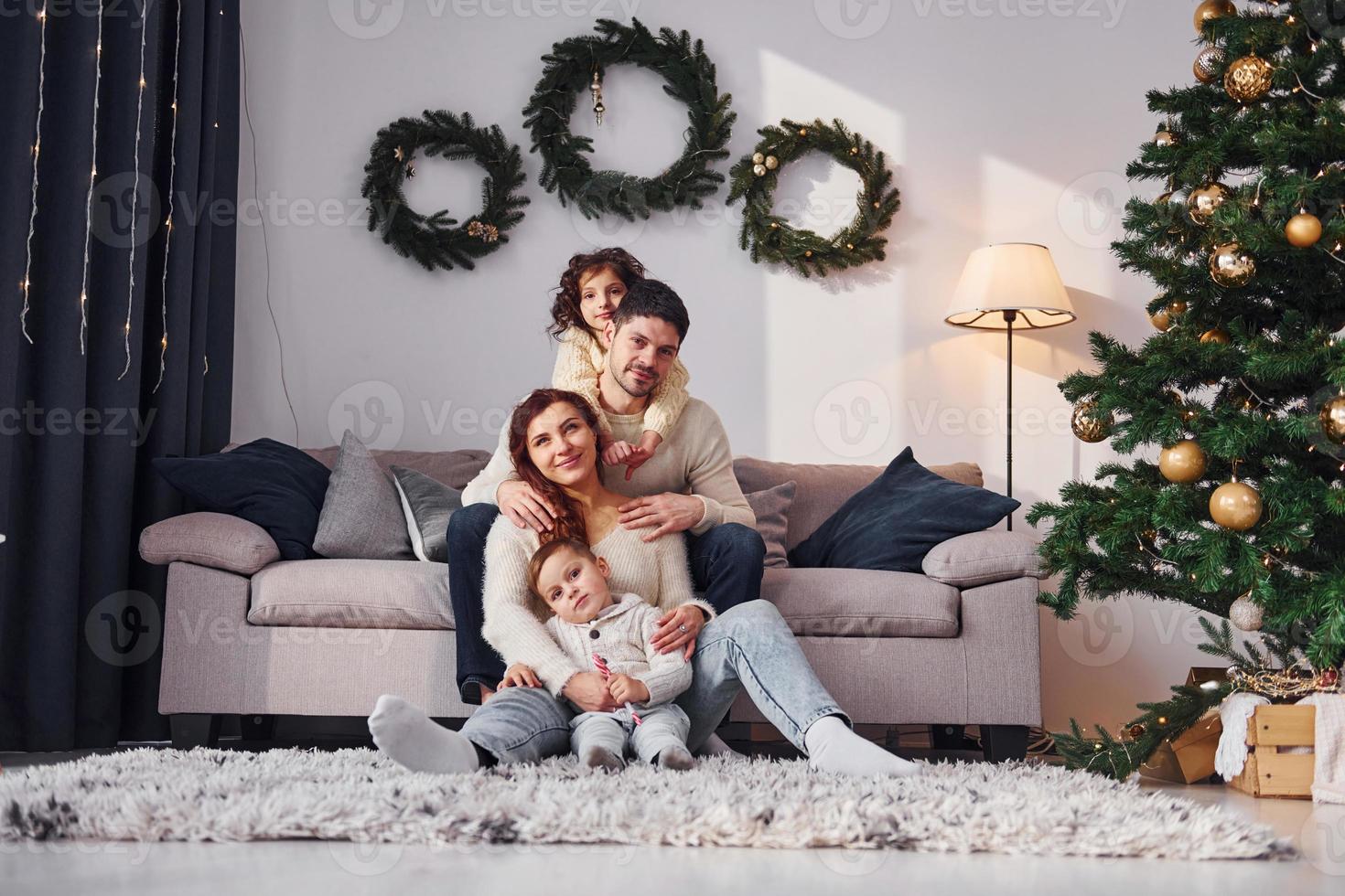 Conception of holidays. Family celebrating new year with their children at home photo