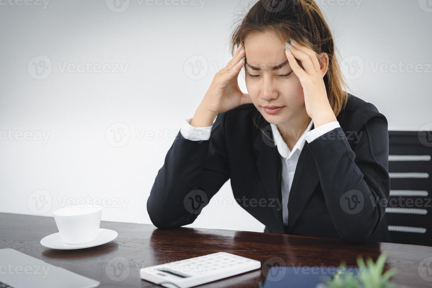 stressed girl Feeling headaches due to computer overwork or sedentary lifestyle Employees who are tired of working in the office, Office Syndrome. photo