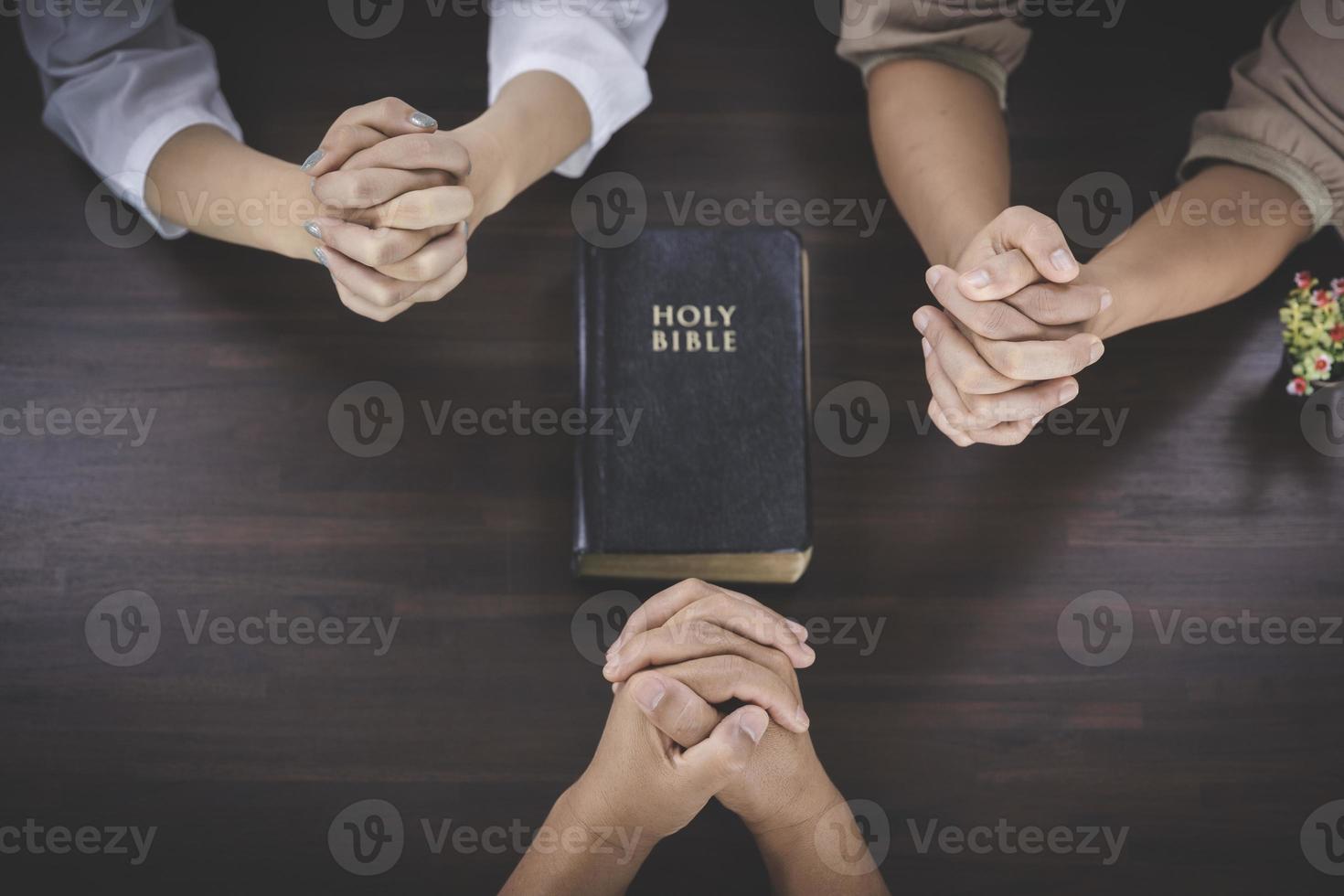 group of women praying together close to the bible Christian bible study concept, faith, spirituality and religion, world day of prayer. International Day of Prayer. photo