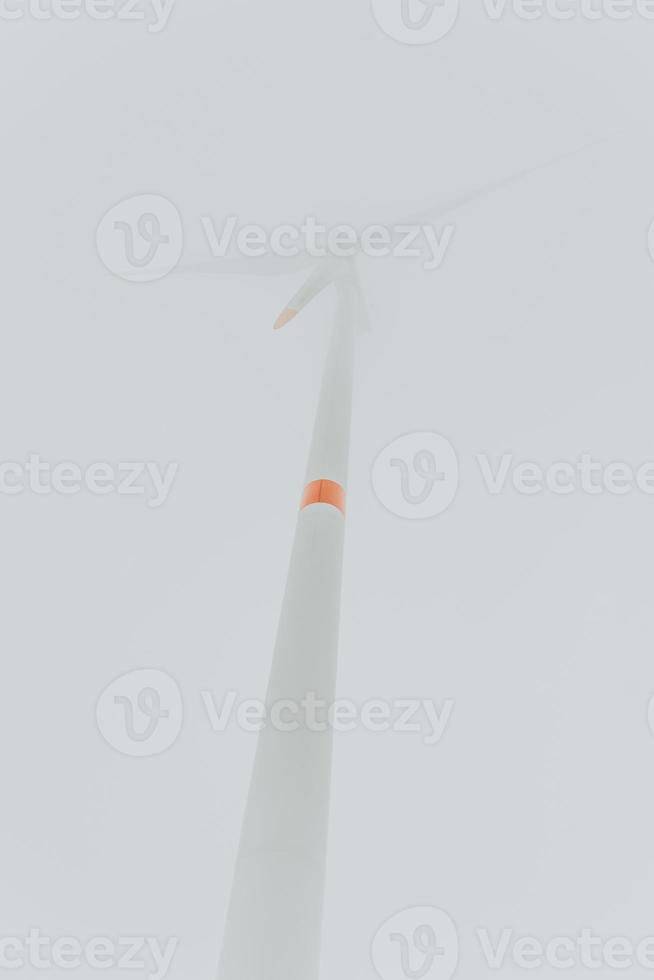 Windturbine in fog from low angle photo