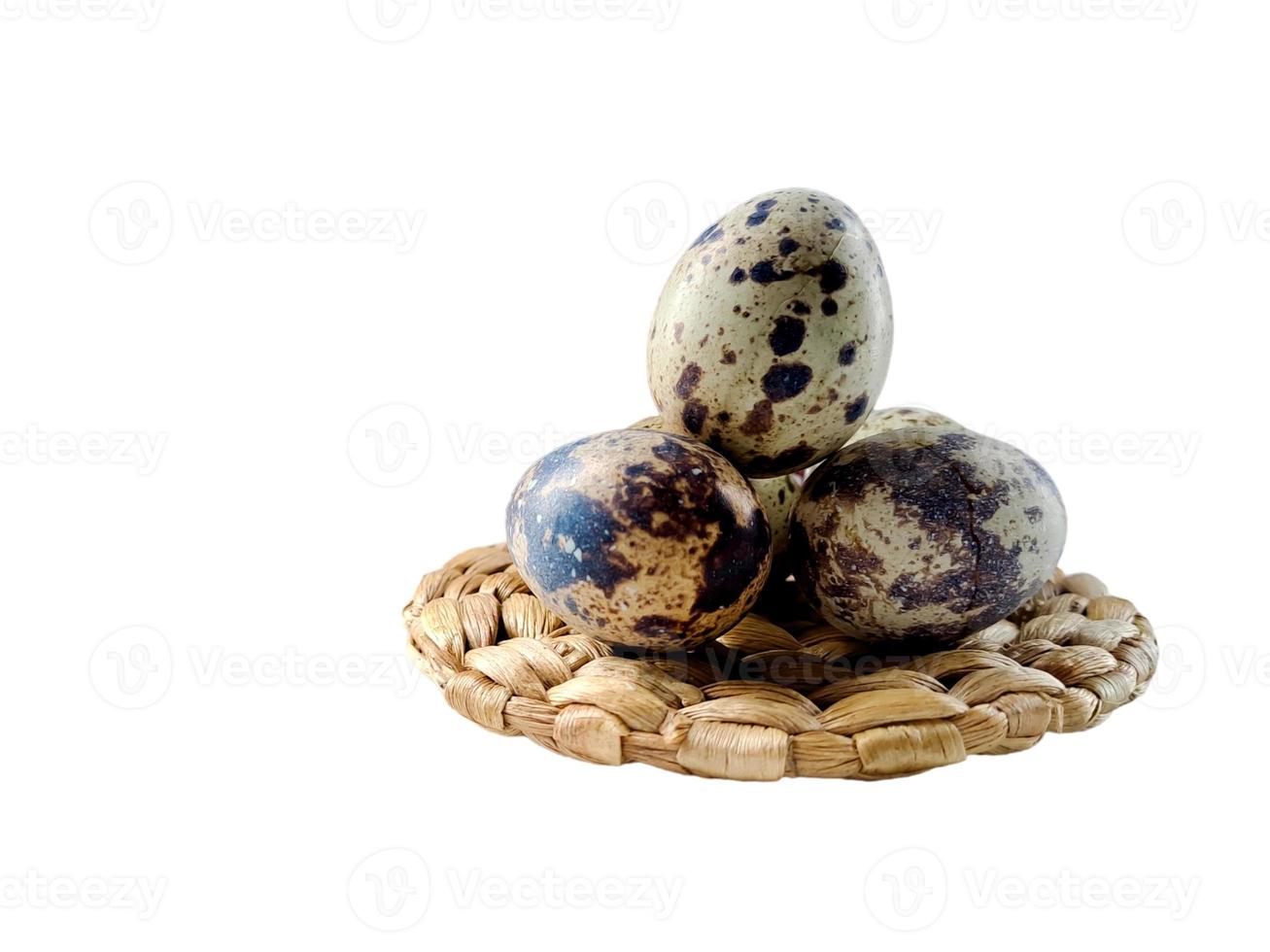 Quail eggs from quail, a collection of quail eggs on a wooden plate with isolated white background photo